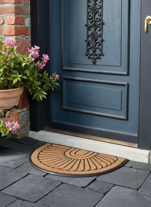Blue door with decorative metal handle, doormat, and potted plants on a stone patio.