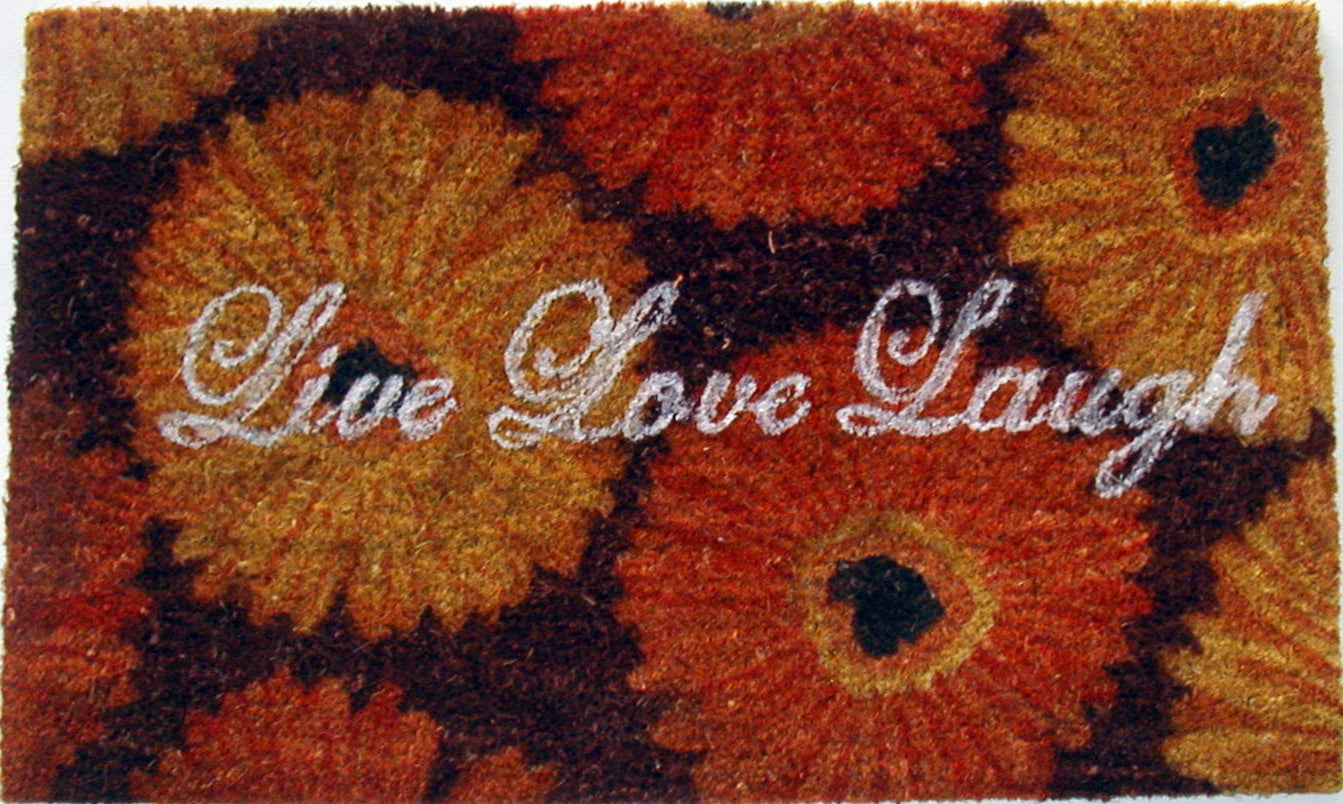 Decorative doormat with floral pattern and 'Live Love Laugh' text on a white background