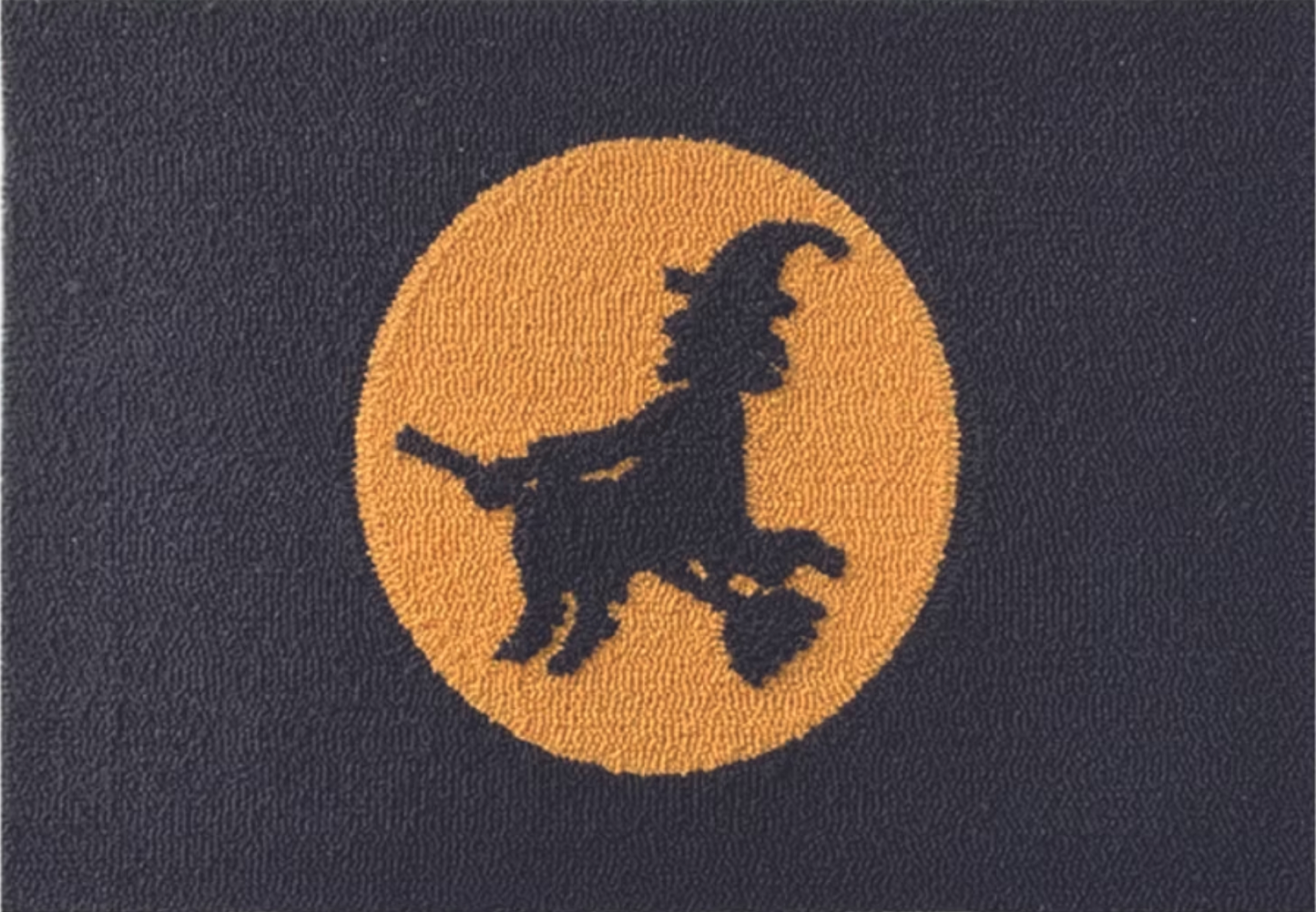 black door mat with witch silhouette and moon design