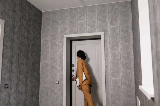 Clean apartment hallway with a small natural coir doormat at a front door