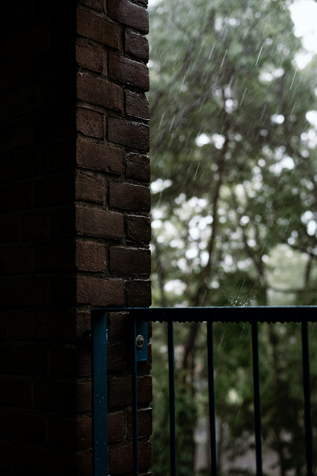 Rainy front porch with a wet doormat at the door
