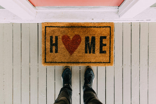 Natural coir doormat at a home front door entryway"