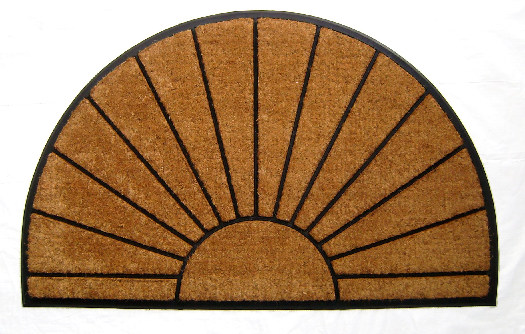 Semicircular doormat with sunburst design on a white background
