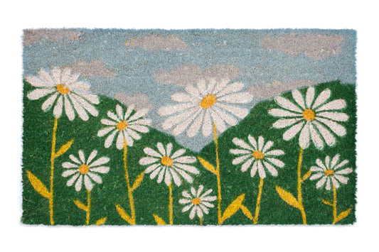 Doormat with daisy flower pattern on a green grass and blue sky background