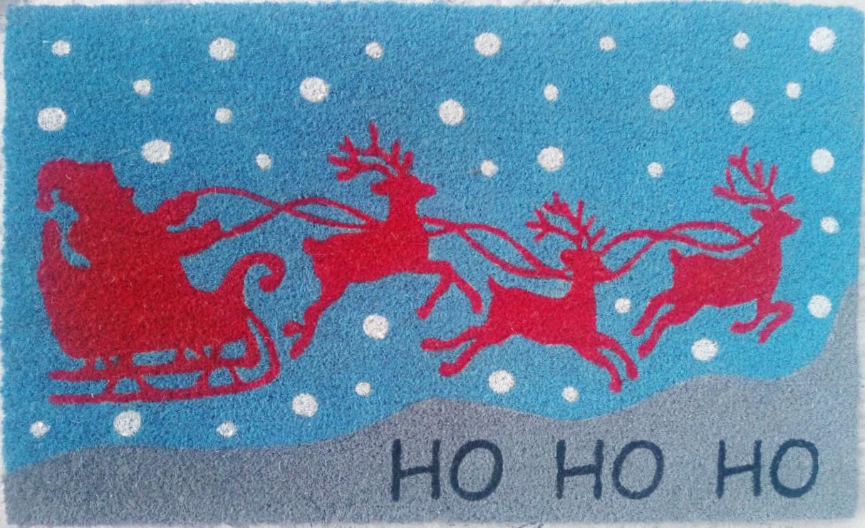 Doormat with Santa Claus in a sleigh pulled by reindeer against a blue background with white snowflakes.