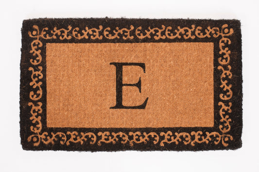 Doormat with decorative border and letter 'E' on a white background