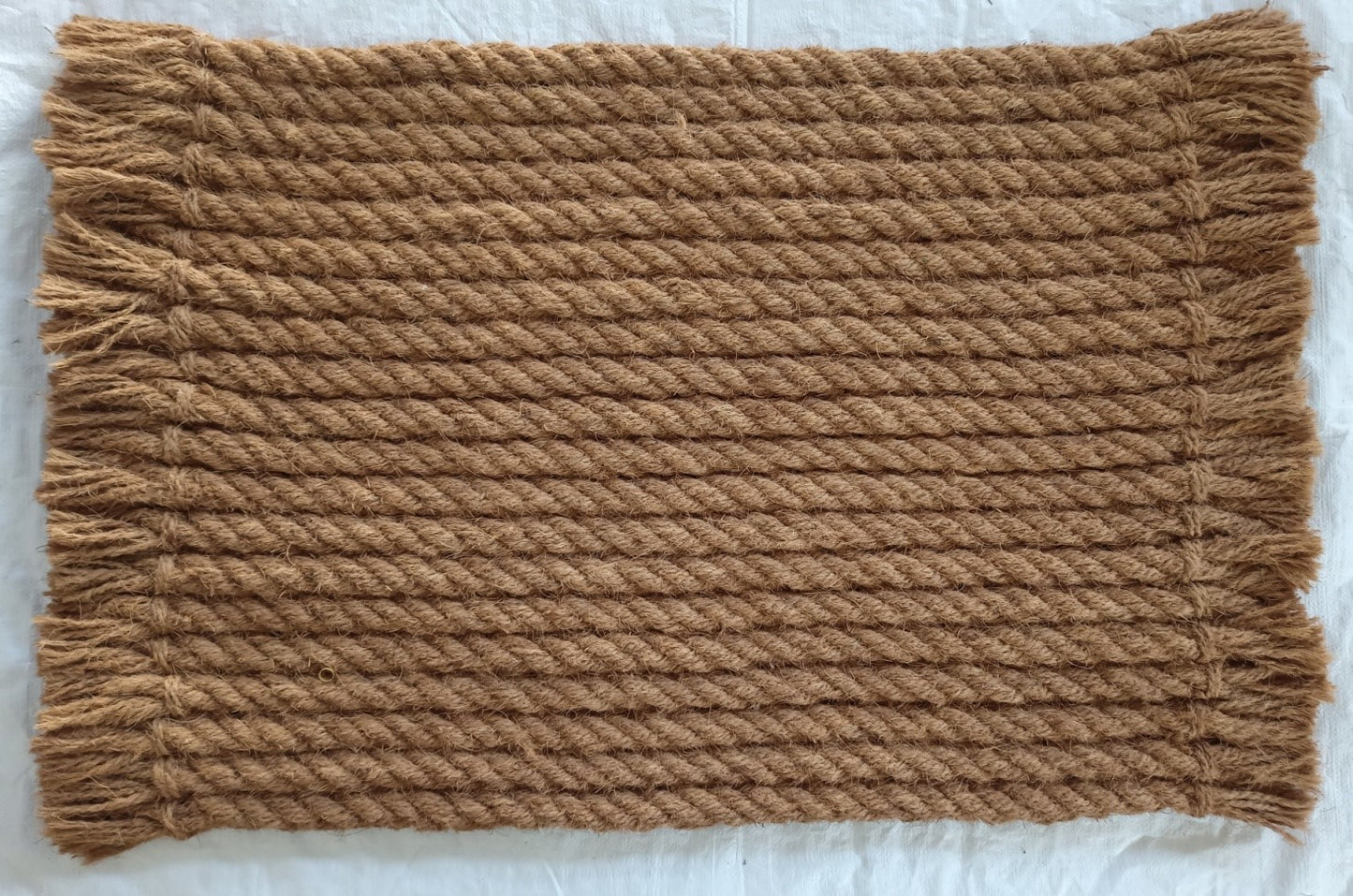 brown door mat with twisted rope pattern and fringed edges