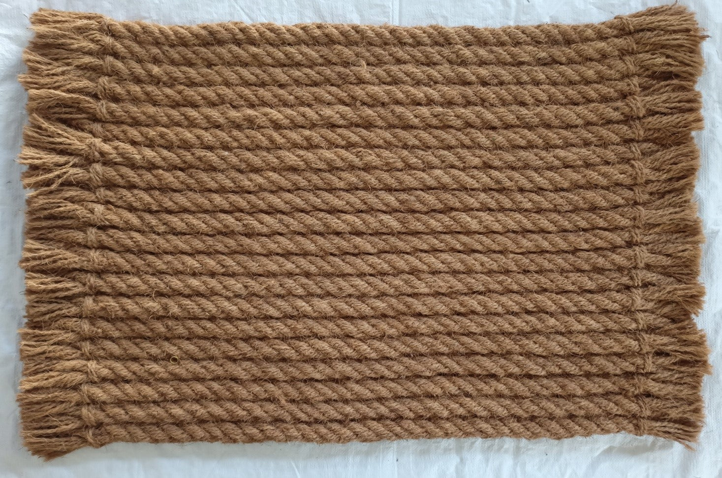 brown door mat with twisted rope pattern and fringed edges