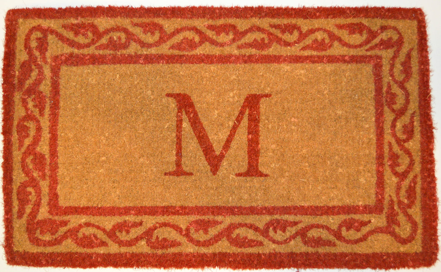 Doormat with a red border and letter 'M' in the center