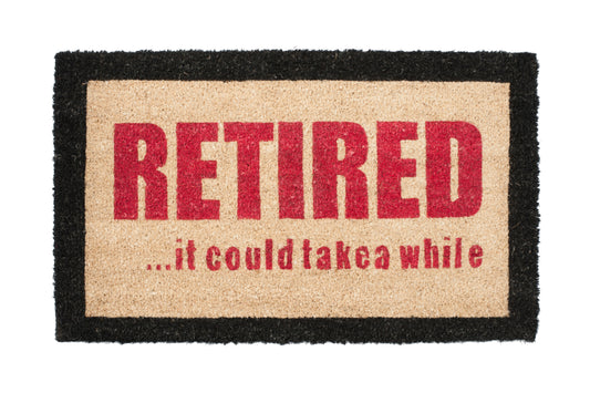 Doormat with 'RETIRED... it could take a while' text on a white background