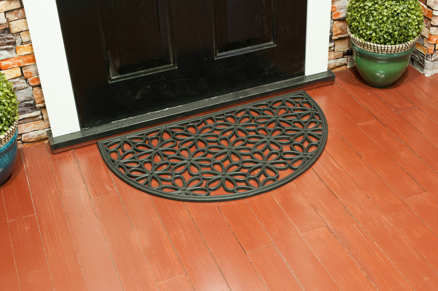 black rubber door mat with semicircle floral flower pattern