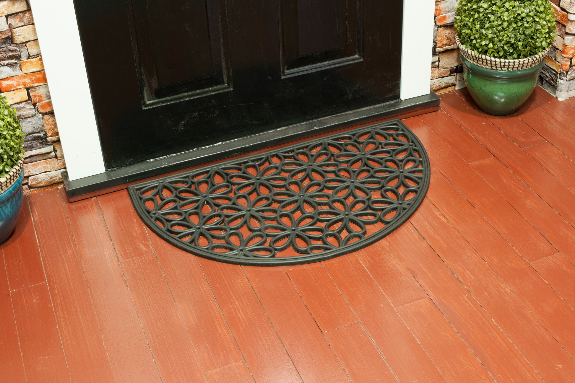 black rubber door mat with semicircle floral flower pattern