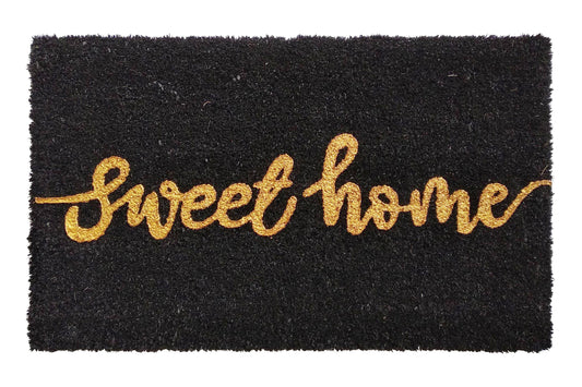 Black doormat with 'sweet home' text in gold on a white background