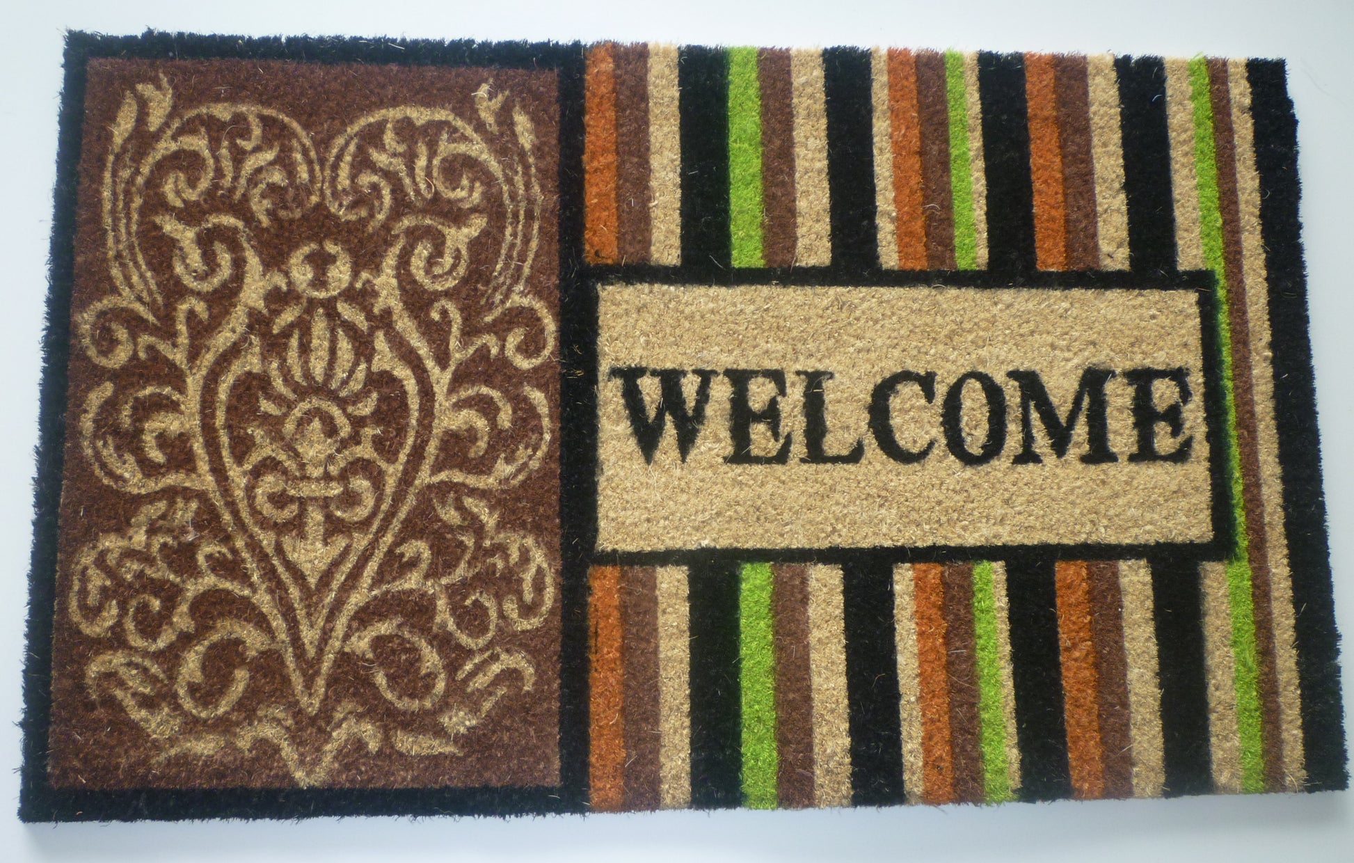Decorative doormat with intricate design and 'WELCOME' text on a striped background